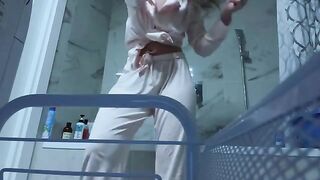 Petite brunette masturbates her tight pussy in the bathroom