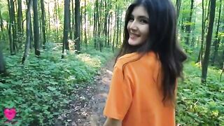 A girl is checking her figure in the forest when a guy passes by