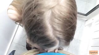 Risky Public Blowjob: A petite schoolgirl gets caught in a daring act in a shop changing room