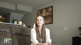 The stepmom, a stunning MILF, shares a couch with her stepson in a taboo roleplay scene