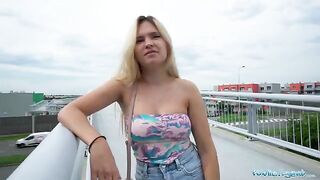 The girl is flashing her tits and ass on the bridge for money