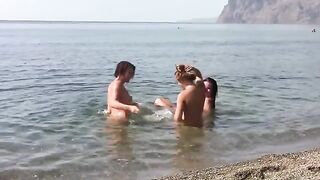 Three naked beauties on the coast, enjoying public nudity on the beach
