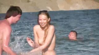 A mature woman is completely naked on the beach