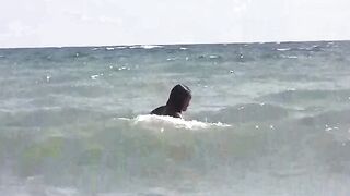 Two charming girls are sunbathing naked on the beautiful beach