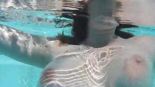 Masturbating with a dildo right in the pool