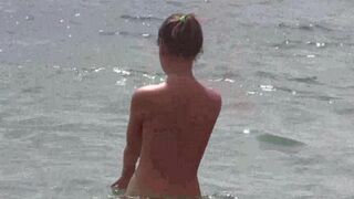 A group of nudists are having a good time on the naked beach