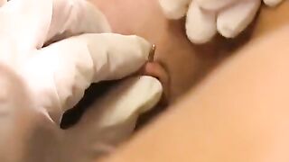 A girl with a clitoris ring plays with a toy and simulates sex