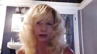 A mature woman has a good time in the bathroom with herself