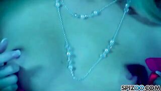 A blonde girl with big breasts masturbating with a dildo