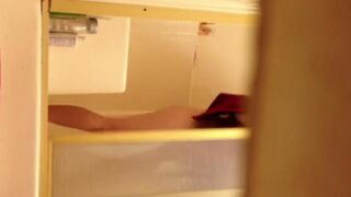 A girl has a shower and is being filmed without her knowledge