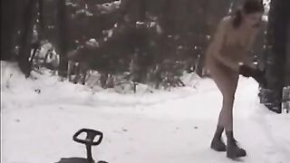 Nude girls are having fun with the snowball in the street