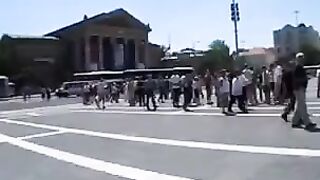 A beautiful model is having fun with a young guy in public place