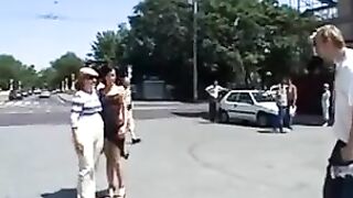 A beautiful model is having fun with a young guy in public place