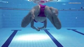 A hot and juicy girl is swimming naked in the pool