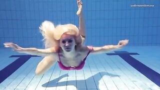 A hot and juicy girl is swimming naked in the pool