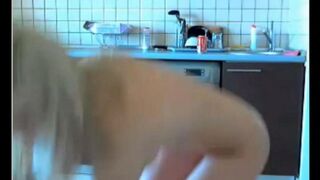 The young beauty has a webcam chat and masturbates in the kitchen