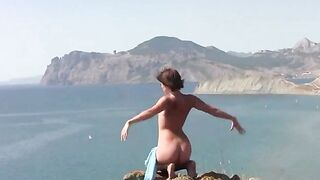 A girl in different poses shows her body on the beach without clothes