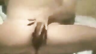 A woman masturbates on the beach, not aware of a hidden camera
