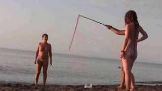Nudist play on a sunny beach day