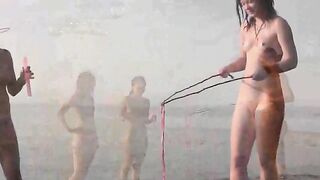 Nudist play on a sunny beach day