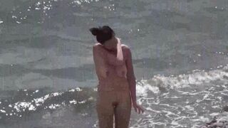 A couple of free-spirited lovers enjoy each other on the nudist beach
