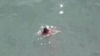 A hot pair of naked people in the middle of the sea