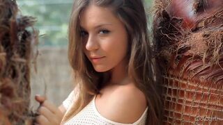 A young Russian model removes her clothes to show her body