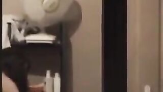 He admires himself in the mirror, completely naked in front of it