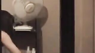 He admires himself in the mirror, completely naked in front of it