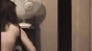 He admires himself in the mirror, completely naked in front of it