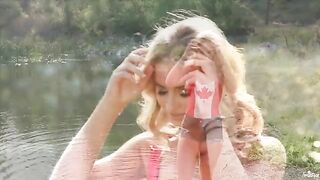 A blonde is tenderly masturbating near the lake in 4K