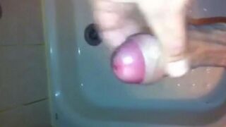 The kid caresses his dick in the shower and masturbates to the end