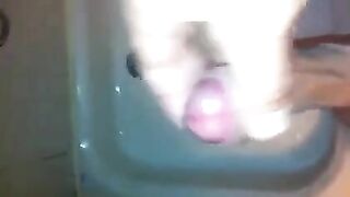 The kid caresses his dick in the shower and masturbates to the end