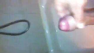 The kid caresses his dick in the shower and masturbates to the end