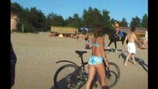 A girl is having fun on the nudist beach without any clothes