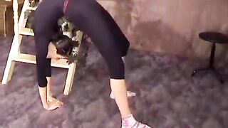 A beautiful gymnast has excellent stretching skills, which she uses for more than just exercises