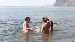 A naked beauty is having fun on the beach