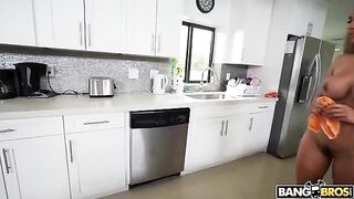 A mature woman is completely naked while she cleans the house