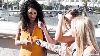 Two girls are stripping on the strip and caressing each other, two guys come in