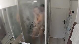 A couple has an intense encounter in the shower, caught up in the heat of the moment