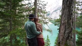 A couple making love outdoors, caught up in a passionate, intimate moment