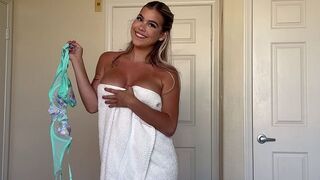A sexy girl is removing her clothes like a wrapping from a sweet treat