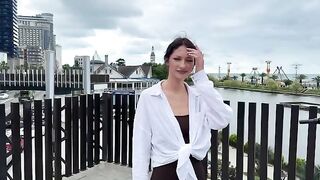 A young beautiful woman signalized for help from a submarine using her bikini